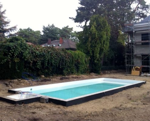 Bauarbeiten in einem Hausgarten, in der Mitte eine Poolkonstruktion
