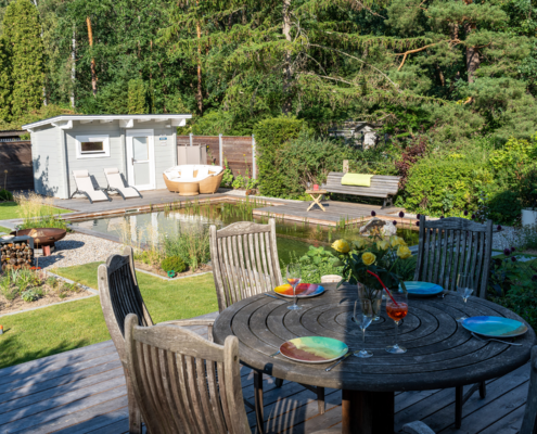 Gartentisch, Schwimmteich im Hintergrund